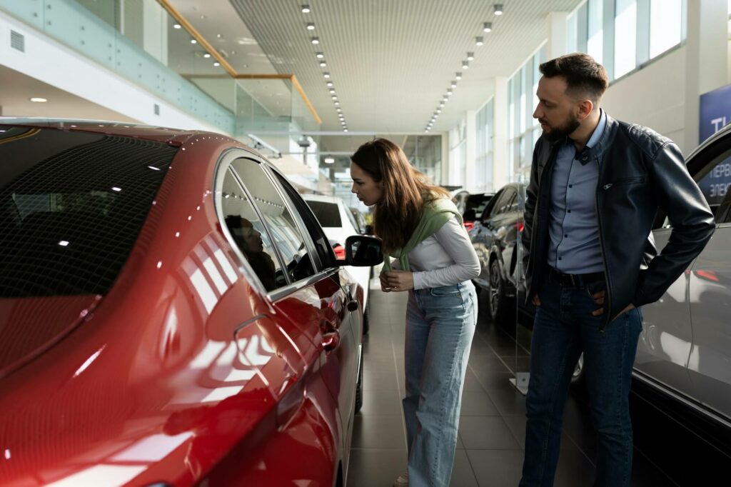 couple chooses a new car in showroom car dealership dealership