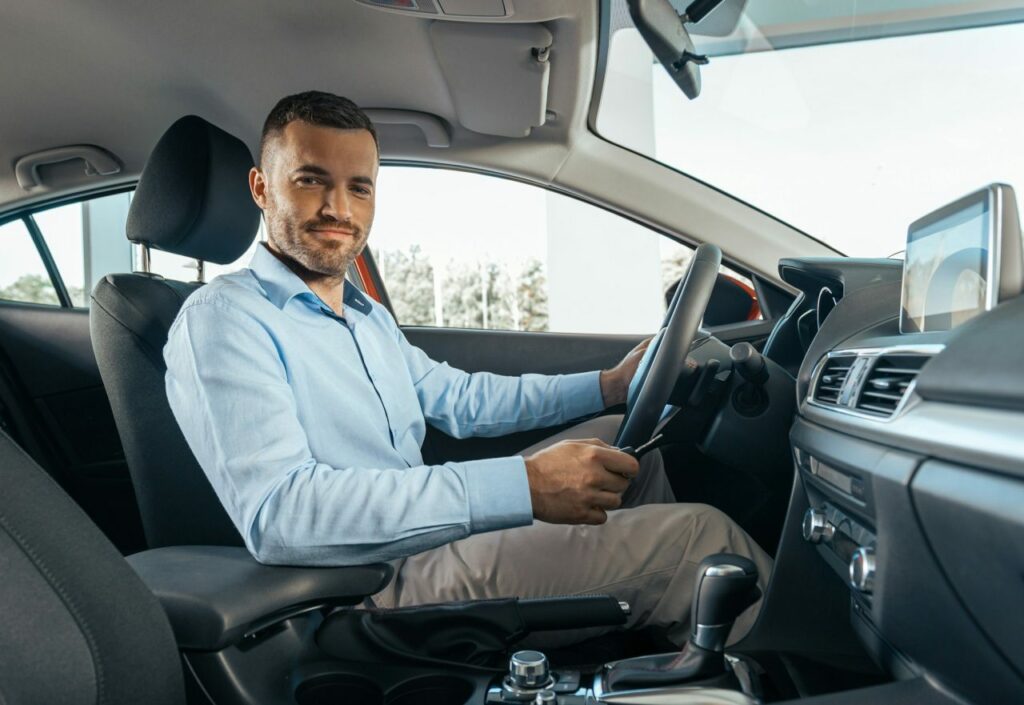young businessman in a car rental service test drive concept